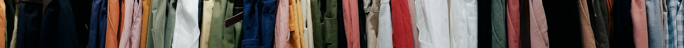 assorted-color clothes lot hanging on wooden wall rack