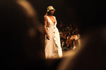 MaisonGrozavu sustainable fashion history showcased on the runway with a model wearing a chic white dress.