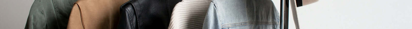 one cowboy hat and five jackets hanged on clothes rack