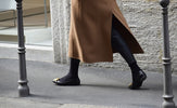 person wearing pair of black ballet flats