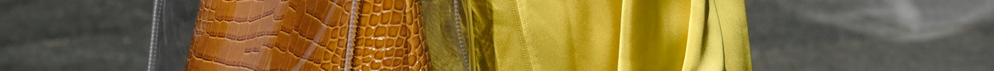 person holding brown leather tote bag