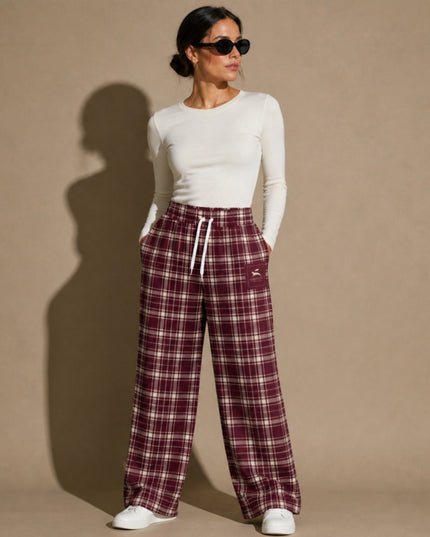 Model wearing the Heritage Tartan Wide-Leg Joggers in Bordeaux in the studio, full-length front view