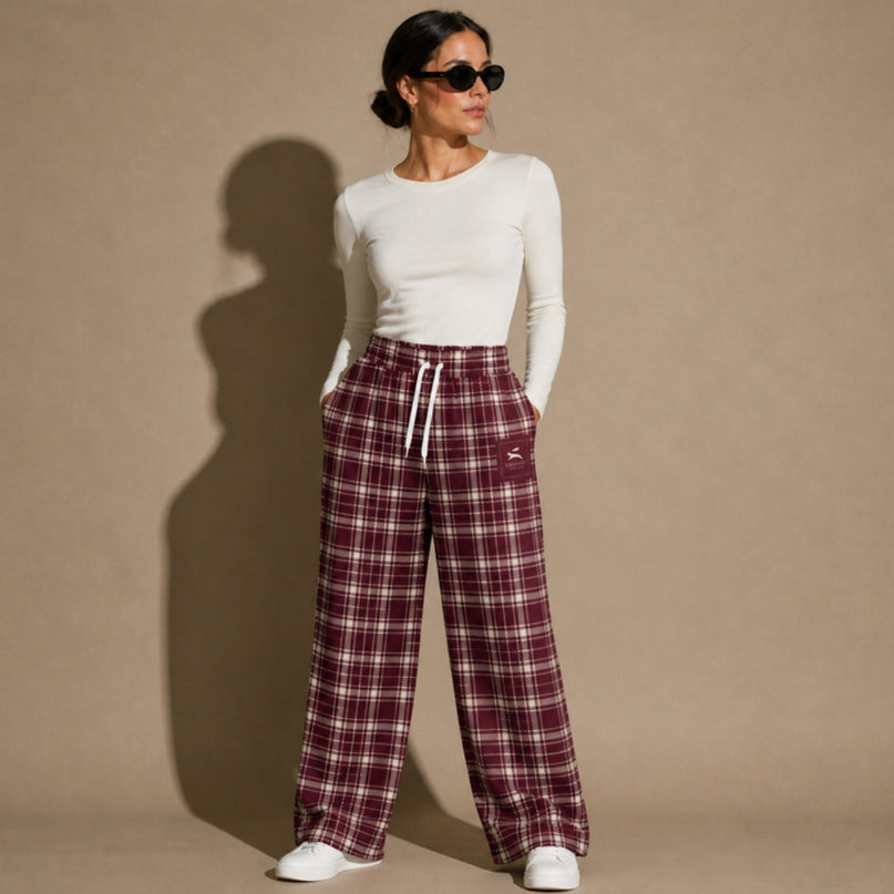 Model wearing the Heritage Tartan Wide-Leg Joggers in Bordeaux in the studio, full-length front view