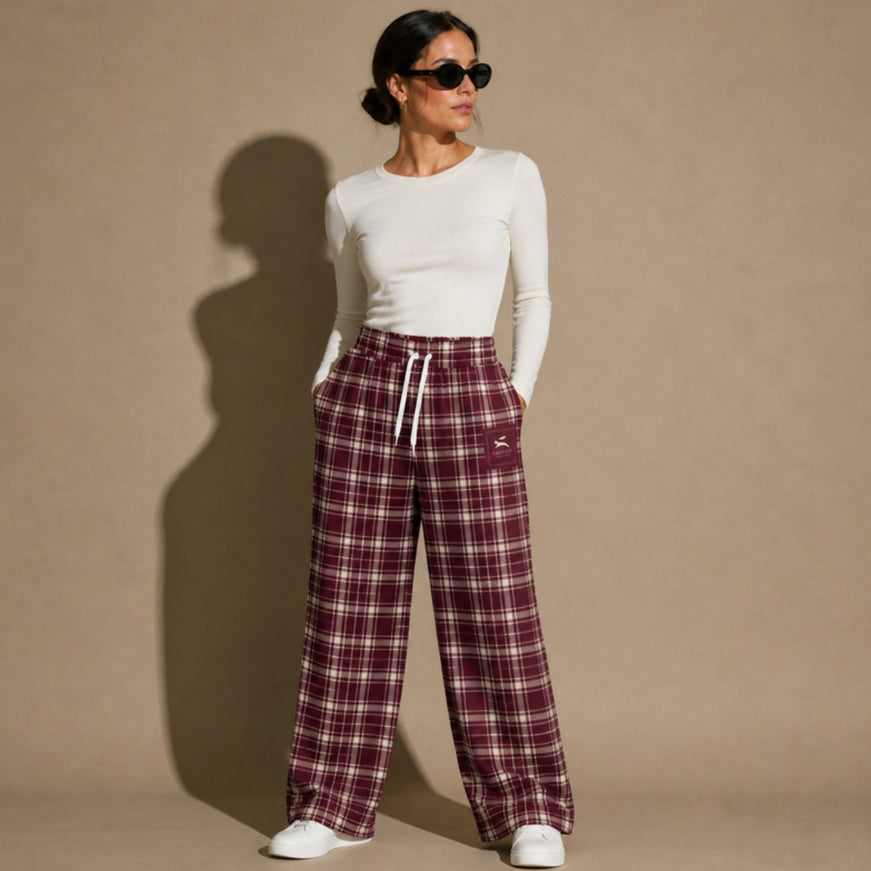 Model wearing the Heritage Tartan Wide-Leg Joggers in Bordeaux in the studio, full-length front view