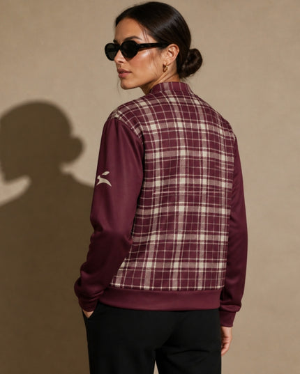 Model wearing the Heritage Tartan Bomber in Bordeaux, back view with the hare on the left sleeve