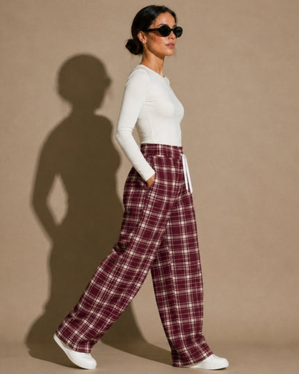 Model walking in the Heritage Tartan Wide-Leg Joggers in Bordeaux, side view