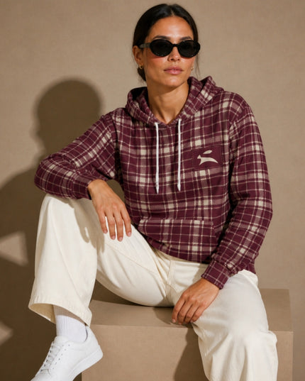 Model seated in the studio wearing the Heritage Tartan Hoodie in Bordeaux