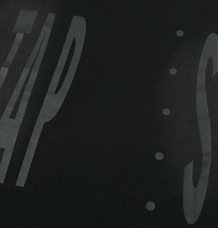 Washed Spray Print TShirt – Loose Fit featuring bold spray-printed lettering on a black background.