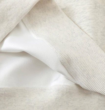 Close-up of the fabric layers of the Slanted Shoulder Retro Graffiti Hoodie, showcasing soft cotton blend texture.