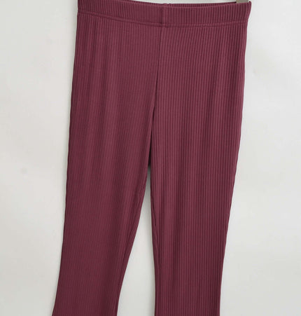 Slim Fit Low Waist Slightly Flared Pants displayed on a hanger, showcasing the ribbed texture and subtle flare hem.