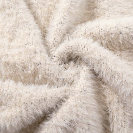 Close-up of soft, beige fabric texture used in the Floral Jacquard Knit Cardigan – Loose Fit.