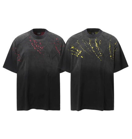 Retro Splatter Print TShirt – Loose Fit featuring a playful faded splatter design in red and yellow on a black background.