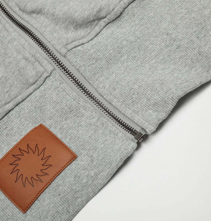 Close-up of Washed Retro Zip Hooded Jacket – Fitted showing zipper and leather patch detail.