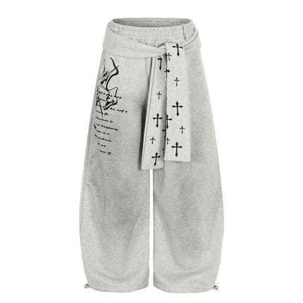 Model wearing Black graffiti cross dirty curved sweatpants by Grozavu