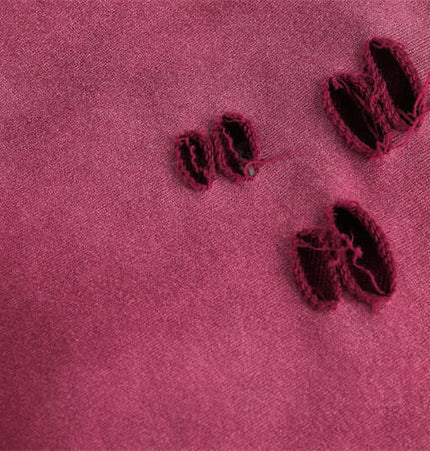 Close-up of fabric with distressed details, showcasing the texture and worn-in style of the Half-Zip Printed Hoodie – Loose Fit.