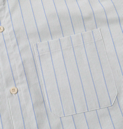 Close-up view of the Patch Striped Short Sleeve Shirt - Loose Fit with light blue and white stripes.