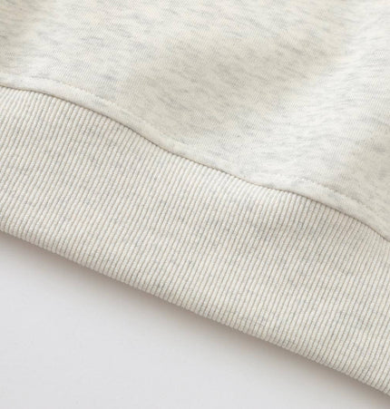 Close-up view of the fabric detail from the Slanted Shoulder Retro Graffiti Hoodie, showing soft texture and ribbed hem.