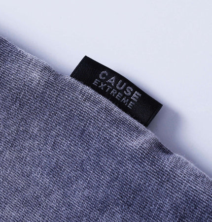 Close-up of the label on the Grozavu Retro Tie-Dye Spliced TShirt – Loose Fit showcasing brand 'CAUSE EXTREME'.