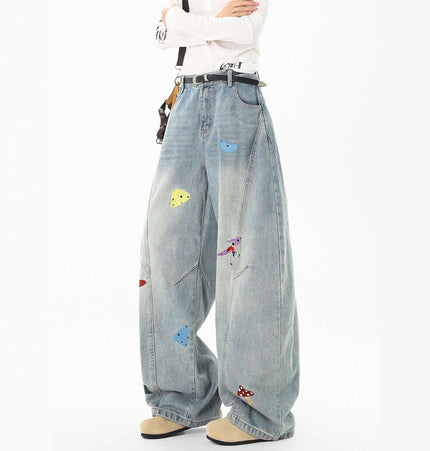 Embroidered Patchwork Denim Pants featuring playful embroidery and a loose fit, ideal for urban streetwear style.