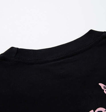 Butterfly Print TShirt – Loose Fit close-up of neckline and distressed butterfly print on black fabric.