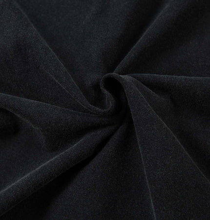 Close-up of soft, black fabric showcasing its smooth texture for apparel like the Retro Washed Badge Letter TShirt – Loose Fit.