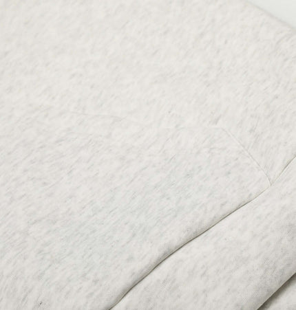 Close-up of the fabric and pocket detail on the Velvet Hooded Jacket - Loose Fit in grey.