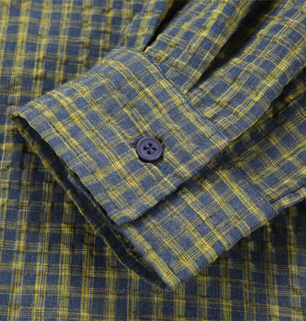 Casual Plaid Shirt – Relaxed Fit close-up of shirt cuff with black button and plaid pattern in blue and yellow.