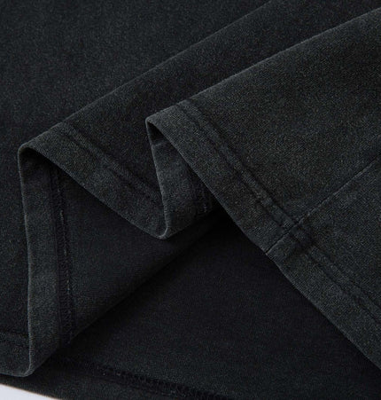 Close-up of the fabric texture of the Retro Washed Badge Letter TShirt – Loose Fit, showcasing its vintage washed finish.