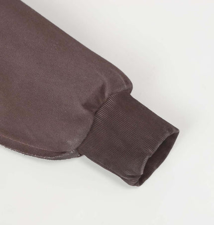 Detail of the sleeve of an Old Patchwork Hoodie – Loose Fit, showcasing smooth fabric and ribbed cuff.