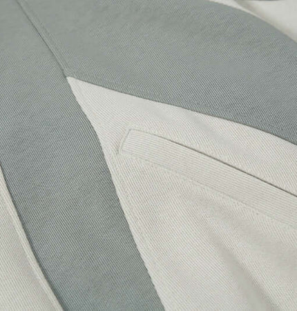 Detail of the Grozavu Color-Block Hooded Jacket – Loose Fit showcasing the stylish color-block design and pocket.