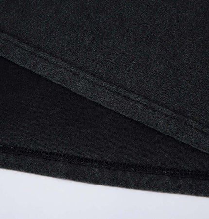 Close-up view of the fabric and stitching of the Retro Washed Badge Letter TShirt – Loose Fit.