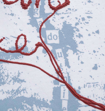 Close-up of the graphic print on a Retro Washed Face Letter TShirt – Loose Fit featuring a red thread design.