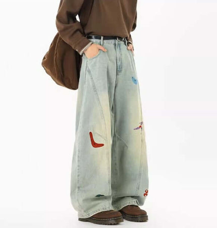 Embroidered Patchwork Denim Pants featuring playful embroidery and a loose fit for trendy streetwear style.