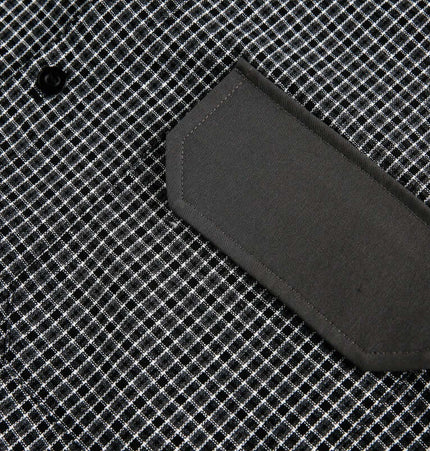 Checkered Patchwork Shirt - Loose Fit with patch pocket and button detail on a black and white checkered pattern.
