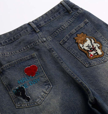 Vintage Washed Cartoon Embroidered Jeans featuring playful towel embroidery on back pockets.