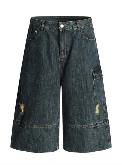 Model wearing Blue washed distressed denim 7/8 pants by Grozavu