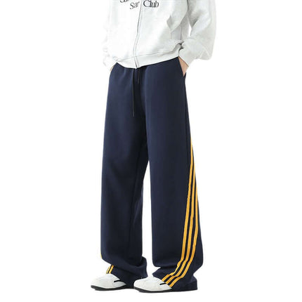 Heavyweight Three-Stripe Pants - Loose Fit in navy with yellow stripes for sporty comfort and style.