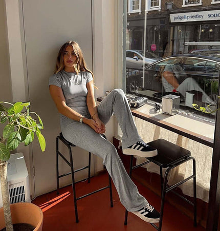 Pleated Short Sleeve Pants Set – Loose Fit worn by a woman sitting in a cafe, showcasing casual style and comfort.