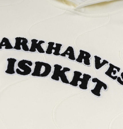 Embroidered Letter Hoodie – Loose Fit featuring bold black lettering on a cream hoodie.