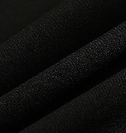 Close-up view of black fabric showcasing texture, ideal for Wide Leg Pleated Plaid Trousers.