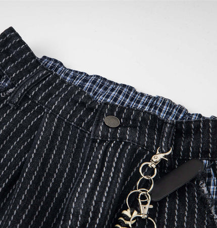 Close-up of the waistband of Retro Striped Embroidery Trousers - Loose Fit showcasing striped fabric and button detail.