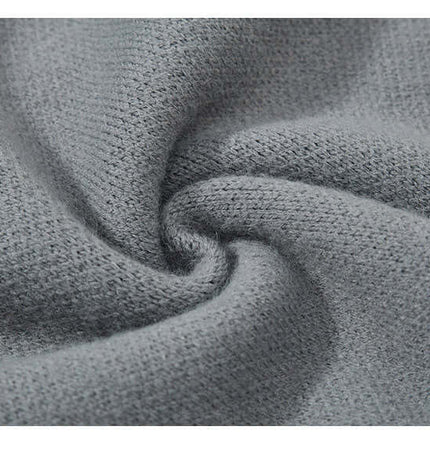 Close-up of soft gray knit fabric, highlighting texture of the Fringe Patchwork Knit Sweater – Loose Fit.