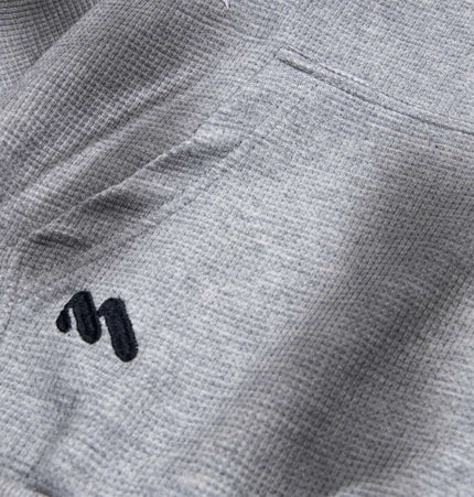 Distressed Letter Zip Hoodie - Loose Fit gray fabric detail with embroidered letter design on pocket