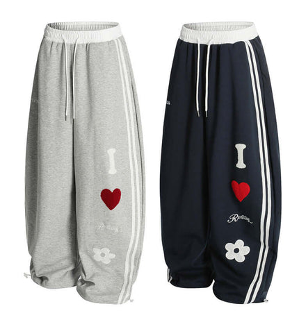 Towel Embroidery Heart Sweatpants in grey and navy with heart graphics and relaxed fit design.