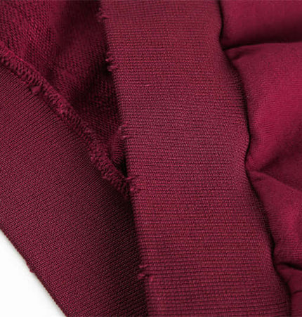 Close-up of the fabric and stitching details of a Half-Zip Printed Hoodie – Loose Fit in a deep burgundy color.