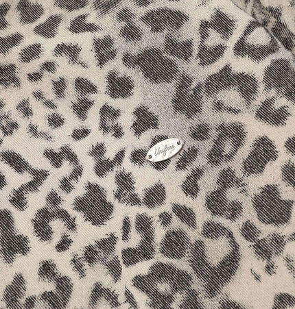 Close-up of leopard print fabric on the Leopard Print Velvet Jacket - Loose Fit, showcasing the stylish design and logo.