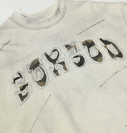 Washed Patchwork Letter TShirt – Loose Fit featuring unique letter embroidery on a washed cotton fabric.