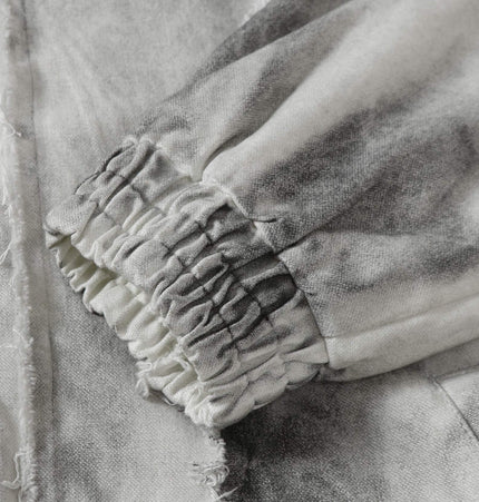 Detail of the Spray Paint Spliced Jacket – Casual Fit featuring unique elastic cuffs and artistic spray paint design.