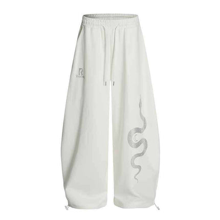 Close-up of White rhinestone snake print pants fabric