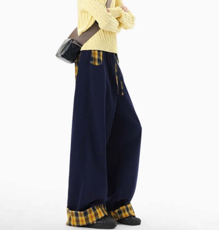 A model wearing Loose Wide-Leg Sweatpants with a yellow sweater and a black bag, showcasing streetwear style.